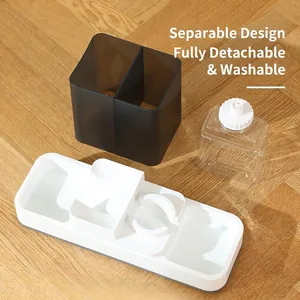 Automatic cat water and food feeder with detachable components on a wood floor