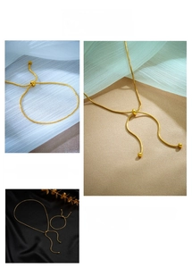 Detail of golden adjustable snake chain jewelry set with sliding bead clasp design