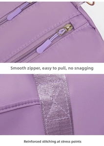Detail of smooth zipper and reinforced stitching on purple fitness travel bag