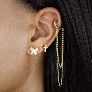 Elegant gold S925 silver earring set featuring butterfly, zircon cross, and chain ear cuff