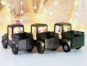 Detail of vintage Christmas truck lanterns with glowing warm lights in three colors