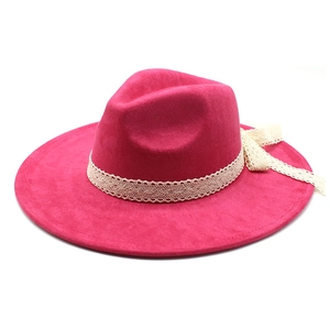 Detail of rose red wide brim wool fedora hat featuring ivory lace ribbon and side bow