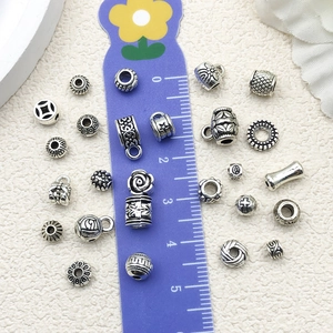 Various antique silver charms and beads set with ruler for scale, 0.5-1cm DIY jewelry parts
