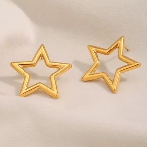 18K gold plated stainless steel hollow star stud earrings on soft textured fabric