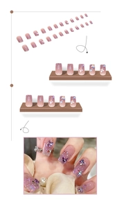 Detail of pink-purple gradient press-on nails with 3D butterfly charms and glitter finish