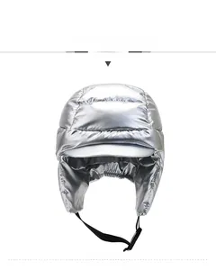 Detail of silver puffer trapper hat featuring windproof fabric and adjustable buckle