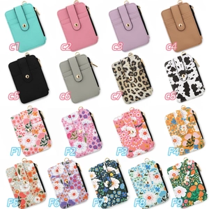 Flat lay of diverse floral print card holders with zipper pockets and metal snaps