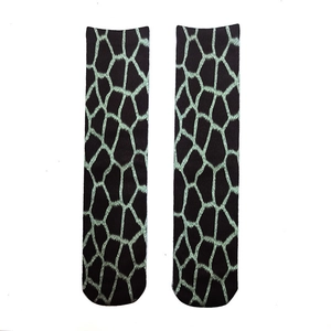 Detailed knit texture of 3D animal paw print socks with green grid patterns