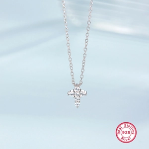 Macro shot of 925 sterling silver cross pendant with clear cubic zirconia stones
