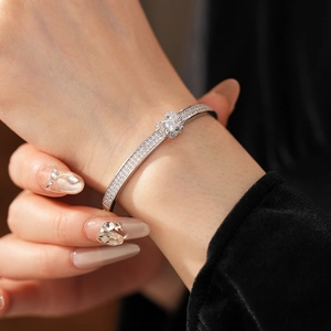 Close-up of silver-tone oval buckle bracelet with pave-set sparkling zircon stones