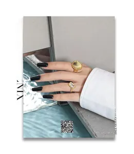 Detail of two-piece vintage gold-plated rings with zircon stone and textured metal bands