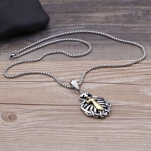 Detailed view of silver hollow cross pendant with golden sword on woven steel chain
