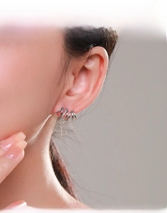 Macro view of sterling silver spiral stud earrings with micro-pave cubic zirconia
