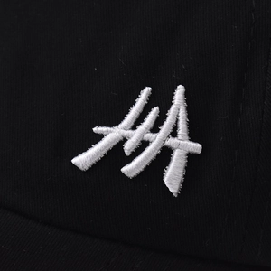 Detail of high-quality white 3D embroidery on black cotton twill ponytail baseball cap