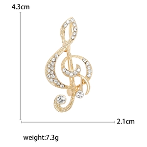 Elegant gold musical note brooch with crystals measuring 4.3cm by 2.1cm and 7.3g weight