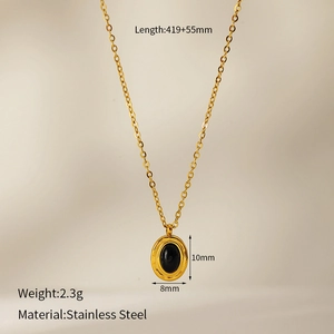 Detailed view of vintage oval black stone pendant on gold plated stainless steel chain