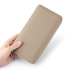 Detailed view of beige pebble grain leather long wallet with silver zipper closure