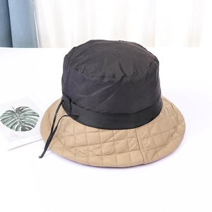 Quilted two-tone down puffer bucket hat for winter featuring black and khaki color blocking