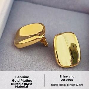 Detailed macro view of minimalist 16x22mm gold plated brass earrings with mirror finish