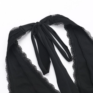 Detailed view of the black lace trim and intricate strap design on a deep V-neck halter top