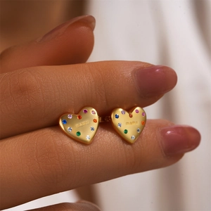Macro view of gold heart stud earring featuring colorful zircons and MAMA engraving