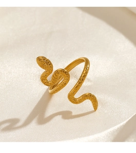 Macro shot of 18k gold plated stainless steel snake ring on white silk background
