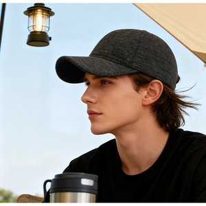 Close-up of dark grey wool baseball cap with Fashion embossing and outdoor camping items