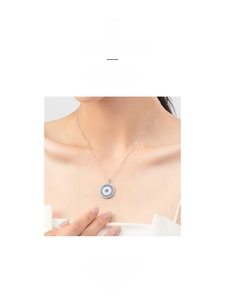 Detailed close-up of s925 silver Evil Eye pendant with turquoise and micro-pave stones