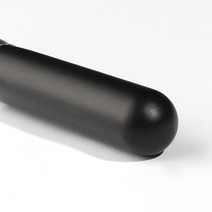 Close-up of matte black round head powder brush with soft bristles for makeup