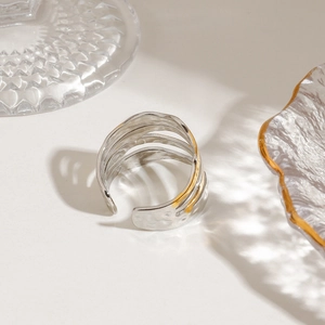 Two-tone geometric open ring with textured hammered finish in gold and silver colors