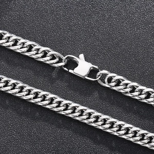 Macro shot of silver titanium steel curb chain necklace with a sturdy lobster clasp