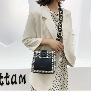 Detail of tweed and leather patchwork crossbody bag with wide jacquard shoulder strap