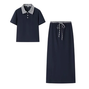 Detail of navy two-piece polo set with black and white checkered collar and drawstring skirt
