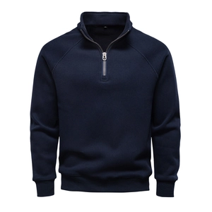 Detailed close-up of dark blue half-zip sweatshirt featuring waffle knit texture and metal zipper