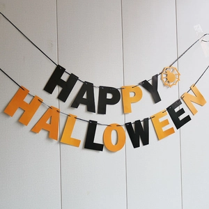 Detail of Happy Halloween paper banner with black and orange swallowtail flags for party