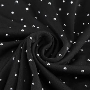 Macro shot of silver rhinestones on elegant black knit fabric with detailed texture