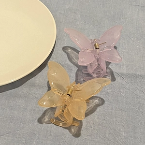 Elegant translucent butterfly hair claw clips in pink and amber for fairy style