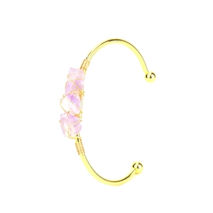Detail of handmade gold wire-wrapped bracelet featuring three raw amethyst stones
