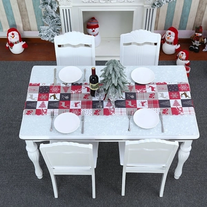 Christmas table runner with reindeer and snowflake patterns on a decorated festive table