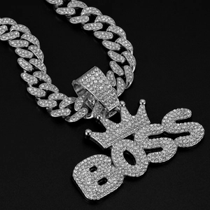 Detail of silver-plated BOSS crown pendant with sparkling rhinestones on Cuban link chain