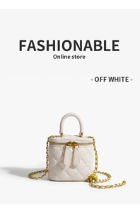 Detail of off-white quilted chain bag showing gold hardware and double zipper closure