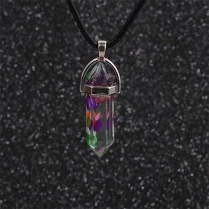 Close-up of hexagonal crystal pillar pendant with colorful chips on a black cord