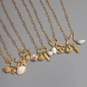 Detail of diverse ocean themed pendants including starfish and seashell on gold chains