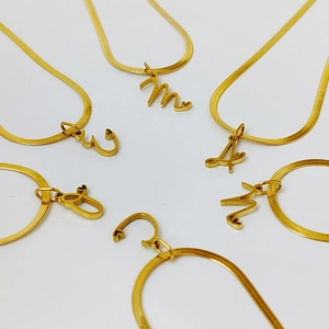 Golden stainless steel letter pendant necklaces with flat snake chain and heart detail