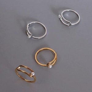 Set of four minimalist geometric gold and silver rings with elegant faux pearls