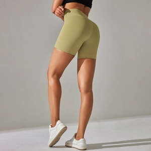 Detail of olive green high-waisted yoga shorts with seamless butt lifting design