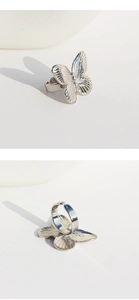 Detailed macro view of a silver 3D butterfly open ring showing intricate metal textures