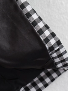 Macro detail of gingham blazer fabric showing precise stitching and contrast lining