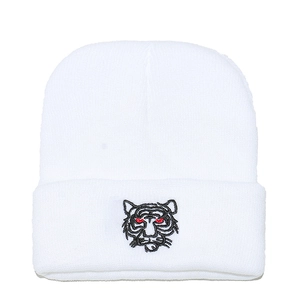 White winter knit beanie with black tiger head embroidery and red eye accents
