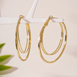 Minimalist gold multi-layer concentric hoop earrings with polished metal finish